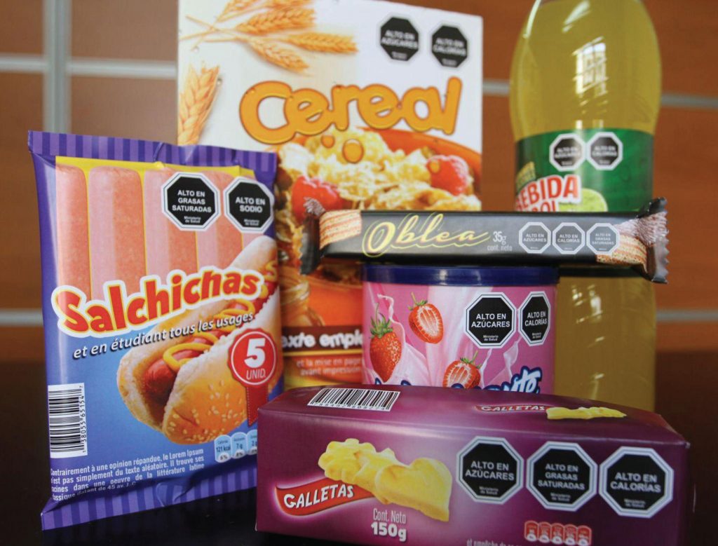 Group of Chilean Food and beverage packages with black, octagonal nutrient warning labels in their upper-right corners
