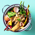 Overhead view of cooking pot filled with food waste scraps